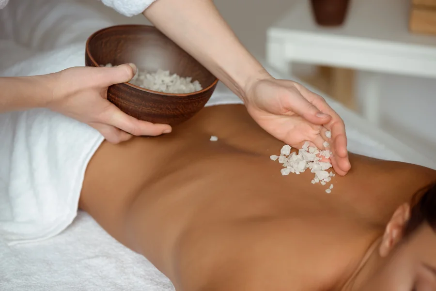A body scrub being applied during a spa session